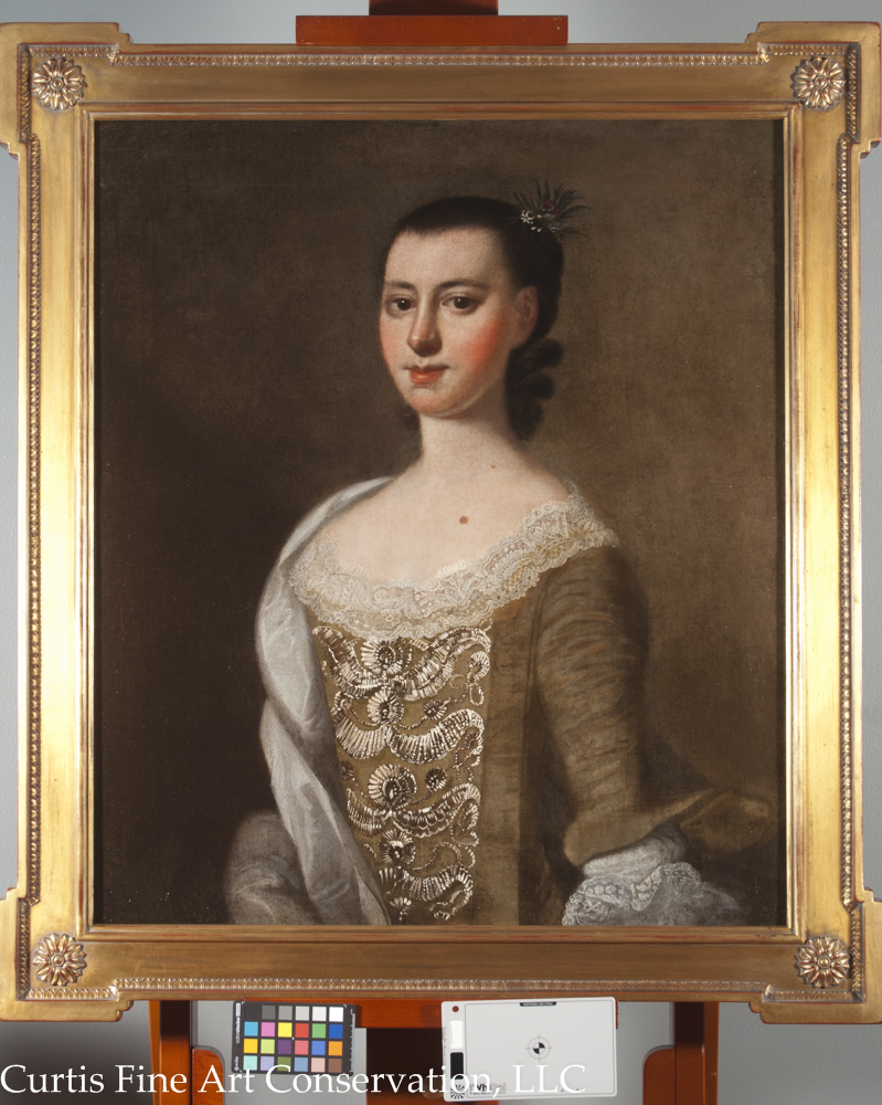 Jeremiah Theus, Portrait of Catherine DuTarque, c. 1774, oil on canvas.  All of the old losses were filled and retouched, allowing the painting to be seen as a complete portrait again.  The original frame was lost long ago and had been replaced by a 19th c. frame that was not appropriate to the period of the painting.  A new, reproduction frame was chosen to complement the picture.